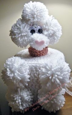 a white stuffed animal sitting on top of a wooden table