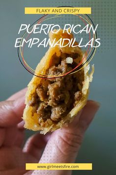 a close up of a person holding food in their hand with the words puerto rican empanadalias