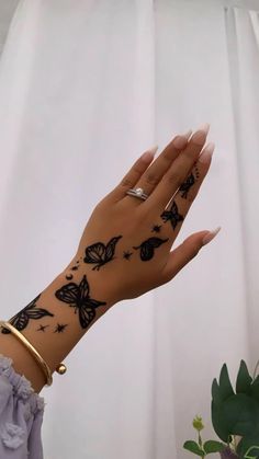 a woman's hand with tattoos on it