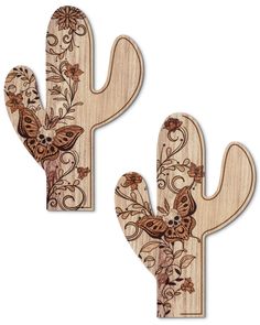 two wooden cactus shaped wall hangings with flowers and leaves on the top of them