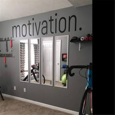 there is a bike and exercise equipment in the room that says motivation on the wall