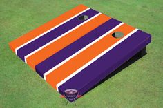 an orange and blue striped cornhole game