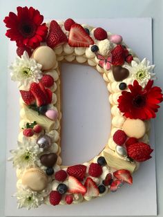 the letter d is made up of fruits and flowers, including raspberries, strawberries, chocolates, and more