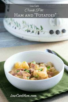 a white bowl filled with ham and potatoes on top of a green napkin next to an instant pressure cooker