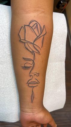 a woman's leg with a rose tattoo on it