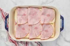 ham and bread in a casserole dish on top of a red white and blue towel