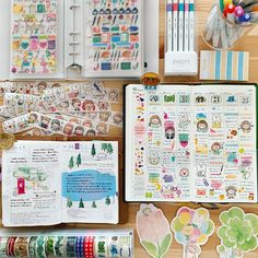 the contents of a planner spread out on a wooden table with markers, pens and washi tapes