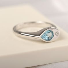 All HANDMADE ITEMS SHIP IN APPROX 8 DAYS Main Stone: Real Swiss blue topaz Main Stone Size: Pear cut 5 mm x 7 mm Main Stone Weight: 0.91 carat Side Stone: CZ Height From The Ring Setting Bottom(to gemstone top): about 4.25 mm Width of Ring band Measure: gradually varied,about 2.34 to 2.97 mm Material: 925 Sterling Silver/14K White Gold/14K Yellow Gold/14k Rose Gold Engraved: Available For FreeNo more than 13 letters) Customized:Of course! Tell me what you want Includes With Order: All of my stor Modern Signet Ring With Birthstone For Promise, Silver Blue Topaz Ring With Polished Finish, Sterling Silver Teardrop Topaz Ring For Anniversary, Modern Topaz Birthstone Ring As Gift, Modern Topaz Ring As Birthstone Gift, Anniversary Teardrop Topaz Ring In Sterling Silver, Blue Signet Ring With Birthstone For Anniversary, Gift Blue Topaz Ring With Polished Finish, Blue Topaz Teardrop Promise Ring