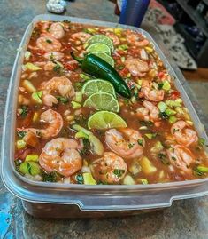 a plastic container filled with shrimp and vegetables