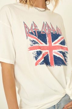 Distressed graphic t-shirt Vintage-style Def Leppard logo print with Union Jack UK flag graphic. Round neckline. Short sleeves. Drop shoulder. Distressed detailing at collar, sleeves, and hem. Loose fit. 100% Cotton. Imported top designed and printed in Los Angeles, CA. Officially licensed Def Leppard merchandise. Not eligible for discounts. Model wears size S. Graphic Tee With Flag Print Short Sleeve, White Distressed Crew Neck Top, White Graphic Tee With Flag Print, Trendy White Distressed T-shirt, White Distressed Grunge T-shirt, Def Leppard Logo, Distressed Graphic Tee, Def Leppard Graphic Tee, Union Jack Shirt