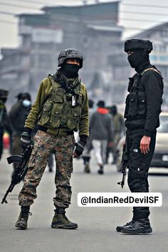 two soldiers standing in the middle of a street