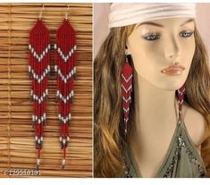 a woman's head wearing red and white beaded earrings next to a mannequin