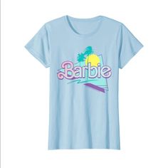 a light blue shirt with the word barbie on it and palm trees in the background