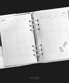 an open planner book on a black background