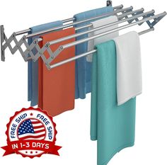 an over the door drying rack with towels hanging from it's hooks and two blue, orange, and white towels