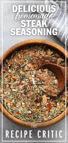 a wooden bowl filled with lots of different types of seasoning on top of a table