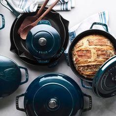 blue cast iron pots and pans with bread in them