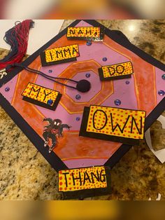 a graduation cap that says i am my own on it with some words cut out