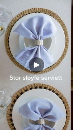 two plates with blue napkins on them and one has a bow at the top