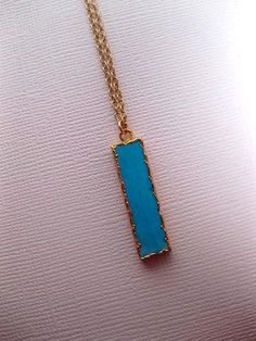 "Vertical Turquoise Howlite Bar Necklace Vertical Turquoise Bar: - Turquoise howlite with 24k Gold electroplated trim - Measures approximately 29mm x 8mm x 5mm Individual pieces vary slightly. We will randomly choose a bar for you. IF YOU WOULD LIKE TO PURCHASE THE HORIZONTAL HOWLITE BAR: https://www.etsy.com/listing/205379468/turquoise-jewelry-howlite-bar-necklace?ref=shop_home_feat_4 YOU CHOOSE A NECKLACE CHAIN finish to go with your Turquoise bar Options are: - Lower cost Gold Plated chain (n Rectangular Blue Turquoise Necklace For Gifting, Blue Rectangular Turquoise Necklace Gift, Turquoise Rectangular Pendant Jewelry Gift, Turquoise Rectangular Pendant Jewelry As Gift, Turquoise Rectangular Pendant Necklace As Gift, Turquoise Bar Necklace, Dainty Gemstone Necklace, Bar Necklace Gold, Turquoise Bar