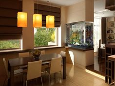 a dining room table and chairs in front of a fish tank