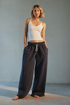 Out From Under sweatpant made special with piping details. Designed in a relaxed wide-leg silhouette featuring a ruffled elastic waistband with drawstring tie, side pockets and split hems. Exclusively at Urban Outfitters. Features Out From Under Hoxton piping wide leg sweatpant Wide leg sweatpant Soft and stretchy knit Ruffled elastic waistline with drawstring tie Side pockets with contrast piping down the sides Split hems Relaxed wide-leg fit Full length Easy pull-on style UO exclusive Content + Care 69% Cotton, 31% polyester Machine wash Imported Size + Fit Model in Ivory is 5’8" and wearing size Small Measurements taken from size small Inseam: 30" | Out From Under Hoxton Piping Sweatpant in Navy, Women's at Urban Outfitters Wide Leg Sweatpants Outfit, Urban Outfitters Sweatpants, Sweatpants Aesthetic, Wide Leg Sweatpants, Contrast Piping, Split Hem, Womens Bottoms, Fashion Forward, Urban Outfitters