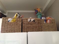 two wicker baskets are sitting on top of the refrigerator's freezer doors