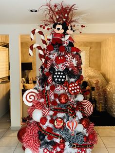 a mickey mouse christmas tree with red and white decorations