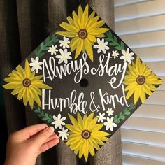 someone is holding up a graduation cap that says, always stay humble and kind