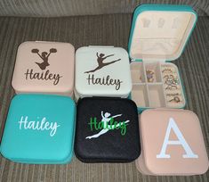 four personalized jewelry cases sitting on top of a couch