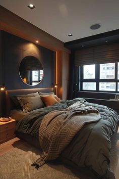 a large bed sitting next to a window in a bedroom under a round mirror on the wall