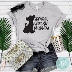 a t - shirt that says small but mighty with a dog's paw on it