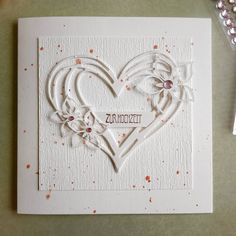 a white card with an intricate heart cut out