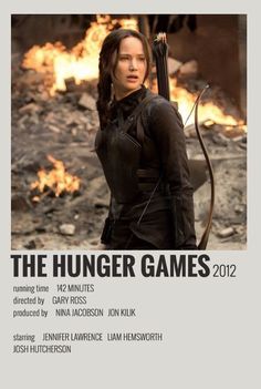 the poster for the movie, katniss everdeen is shown in front of a fire