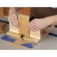 a person is working with woodworking on a piece of plywood and sanding