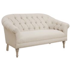 a white couch sitting on top of a wooden frame