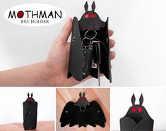 an image of a bat key holder made out of black leather with red eyes and horns