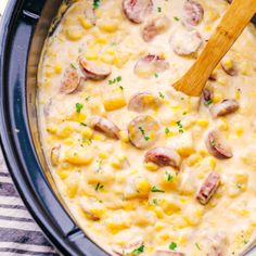 a large pot filled with food and a wooden spoon