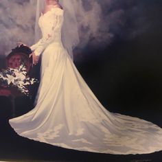 a woman in a white wedding dress standing next to a chair