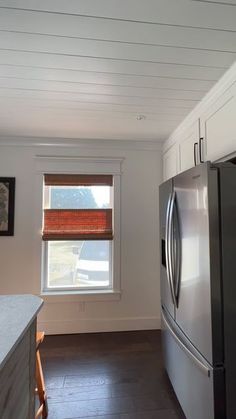 a kitchen with a refrigerator and window in it