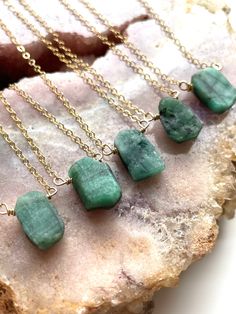 "Rough genuine Emerald has been drilled into beautiful pendants. Each raw emerald gemstone is unique and beautiful in its own way, this necklace offers a beautiful way to wear your favorite gemstone that is dainty and comfortable. Each necklace is made to order and no two are the same. Handcrafted Raw Emerald Pendant Necklace *Beautiful May Birthstone jewelry gift for mom *High quality genuine raw emerald *Raw stones offer stunning unique characteristics *Your choice of chain -- sterling silver Emerald Necklace Gold, Birthstone Jewelry Mothers, Emerald Pendant Necklace, Rock Identification, Beautiful Pendants, Emerald Necklace Pendant, Raw Stone Necklace, Raw Stone Jewelry, Gold Moon Necklace