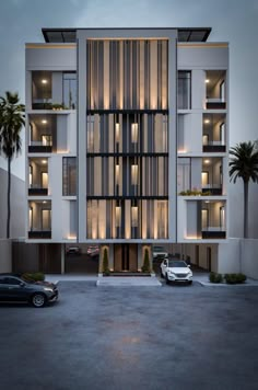 an apartment building with several balconies on the top floor and two cars parked in front