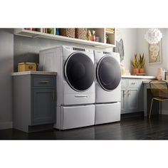 the front load washer and dryer are on display in this modern kitchen setting