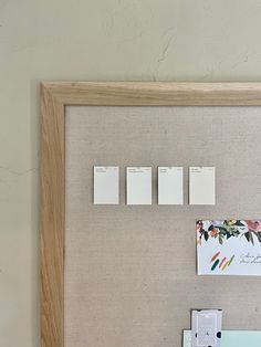 a bulletin board with magnets and papers on it