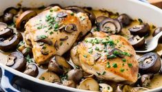 chicken with mushrooms and parsley in a white dish