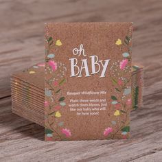 a stack of baby cards sitting on top of a wooden table