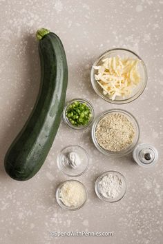 an eggplant, parmesan cheese, and other ingredients are arranged in bowls