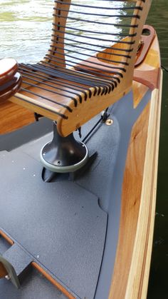 a wooden chair sitting on top of a boat