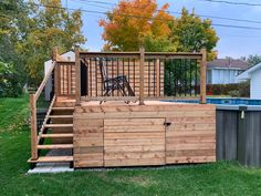 an above ground swimming pool with steps leading up to it and a deck in the middle