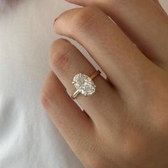 a woman's hand with a diamond ring on it